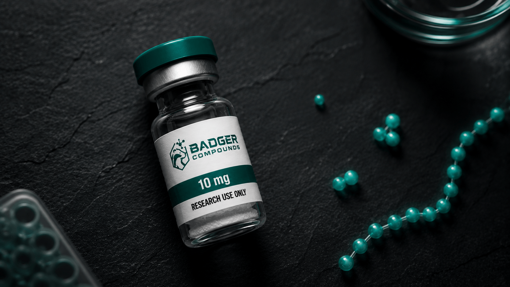 Peptides vs small molecules illustrated by a research peptide vial on a lab bench with a size-scale of molecules